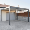 Carport ESSENTIEL Coclic Alu loin devant un garage